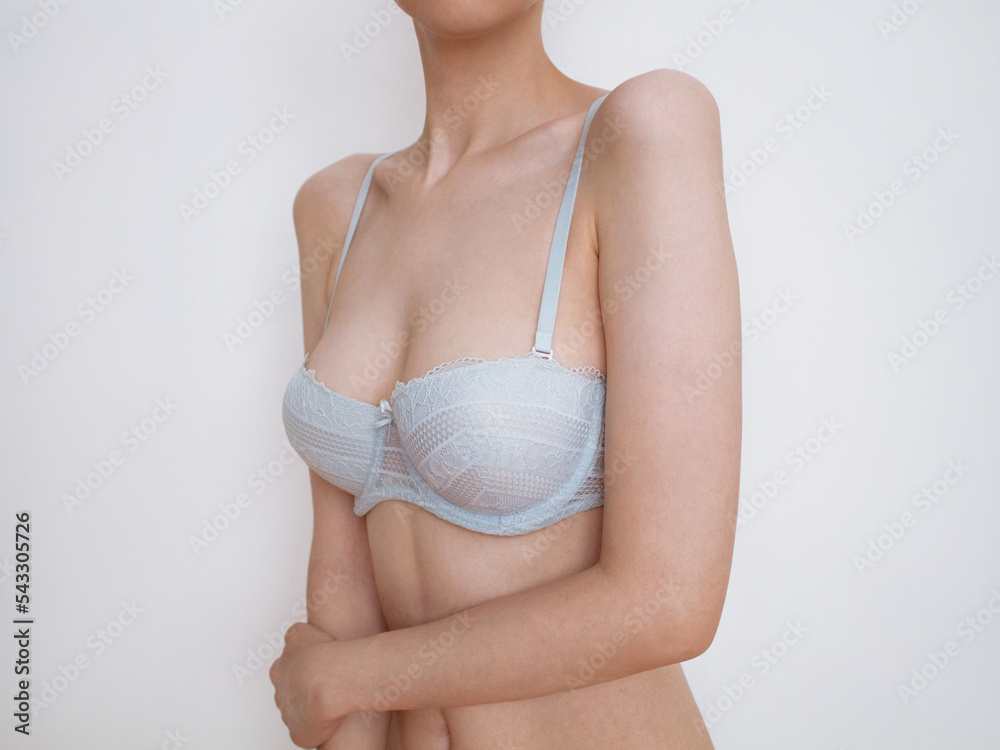 close up of female breast. Woman breast or big natural tits in lingerie.  Plastic surgery. Photos | Adobe Stock