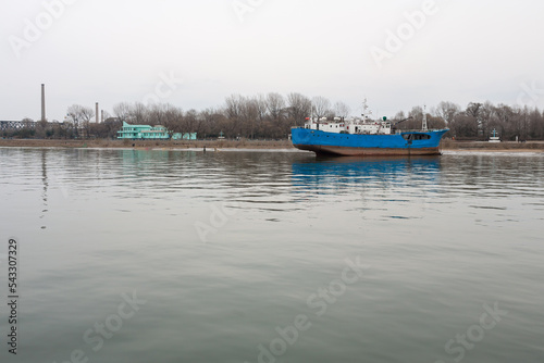 DANDONG, CHINA: boats docked in Sinuiju, North Korean side of Yalu River photo