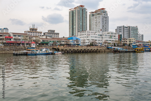 DANDONG, CHINA: the modern chinese city, seen from the Yalu river, facing the North Korean shore in Sinuiju photo