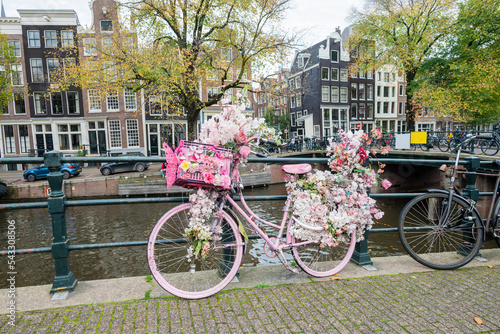 beautiful view of the canl in the city center of amsterdam the netherlands with bicycles with bouquets and flowers