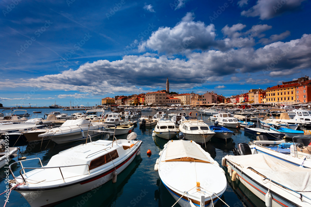 Wonderful view of old  Rovinj town with multicolored buildings and yachts moored along embankment, Croatia.
