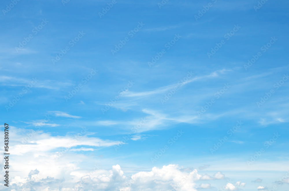 The sky is large, bright, beautiful and has white clouds.