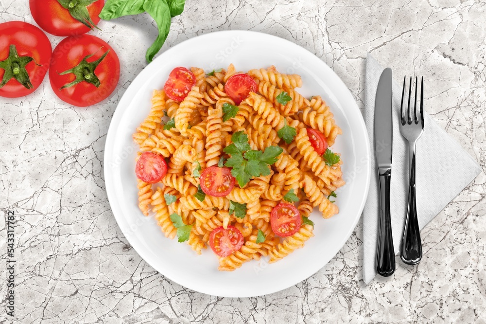 Italian pasta dish with cheese, tomato and fresh vegetables.