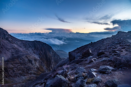Sunset between clouds and rocks of the Cayambe volcano