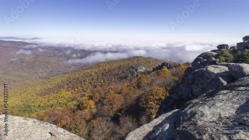 The summit of Old Rag Mountain in Shenandoah National Park in Madison County, Virginia on a beautiful autumn day. A time-lapse video captures a cloud inversion moving over the colorful forest, farm fi photo