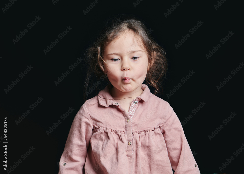 pretty girl making expressive faces in the studio against a black background pretty girl making expressive faces in the studio against a black background