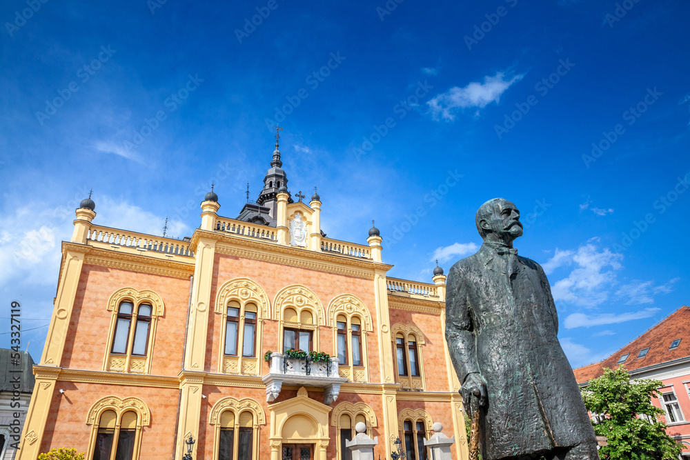 .Facade of Vladicanski Dvor, the Bishop Episcopal palace of Novi Sad, Serbia, with its typical Austro hungarian architecture, with the statue of Jovan jovanovic Zmaj designed in 1894 by Dragan Nikolic