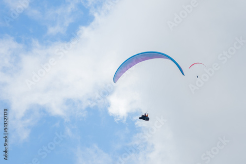 A paraglider flight in a blue sky with clouds.
Paragliding, paraglider, paraglider pilot, flying, fly