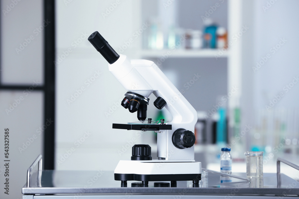 Modern medical microscope on gray table in laboratory Modern medical microscope on gray table in laboratory