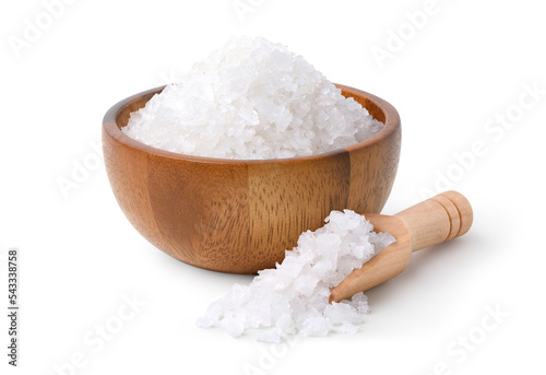 Pure natural sea salt in wooden bowl and scoop isolated on white background.