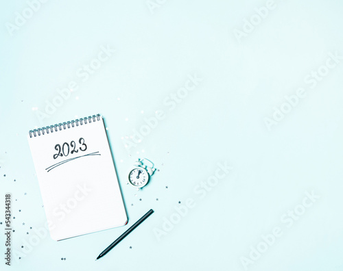 Obraz na płótnie Top view of white vintage alarm clock and empty notebook ready for New 2023 Year planing or wish list w salonie