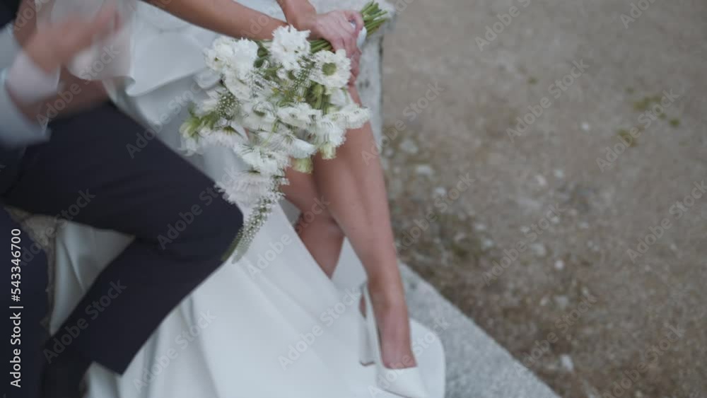 Groom and bride with flower bunch, close-up Groom and bride with flower bunch, close-up