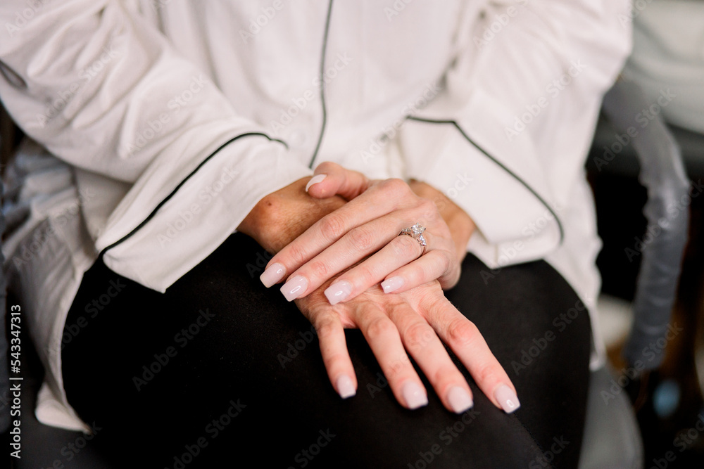 Obraz premium Bride with hands on top of each other wearing an engagement ring 