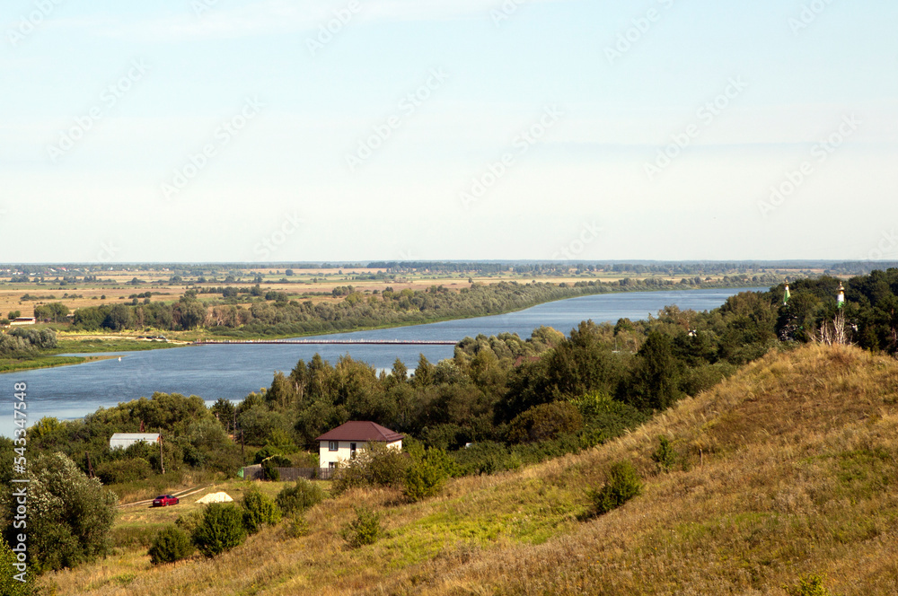 A picturesque view of the Oka floodplain, the village of Staraya Ryazan, the Church of the Transfiguration and the Staroryazansky pontoon bridge. Ryazan Oblast. Russia