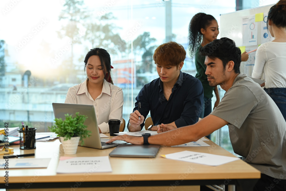 Group of start up business people brainstorming, collaborating on project development in corporate office