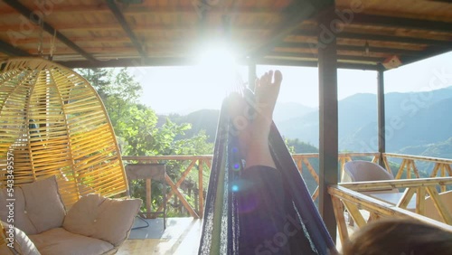 Wallpaper Mural Girl resting and enjoying spending time outside city during vacation or weekend. Young woman relaxing lying in hammock on terrace. Travel around the world wellness wellbeing concept Torontodigital.ca
