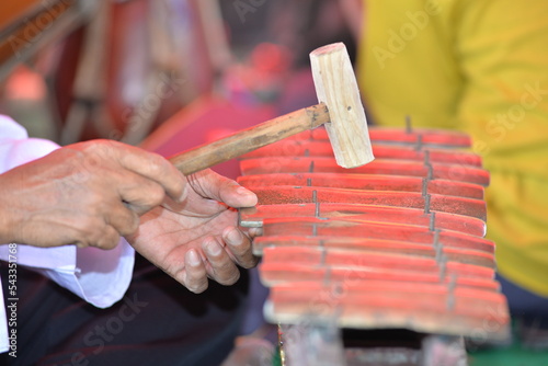 Javanese gamelan made of bronze and wood. Traditional musical instruments from Indonesia. Kening is a traditional Cirebon musical instrument. Focus selected. photo