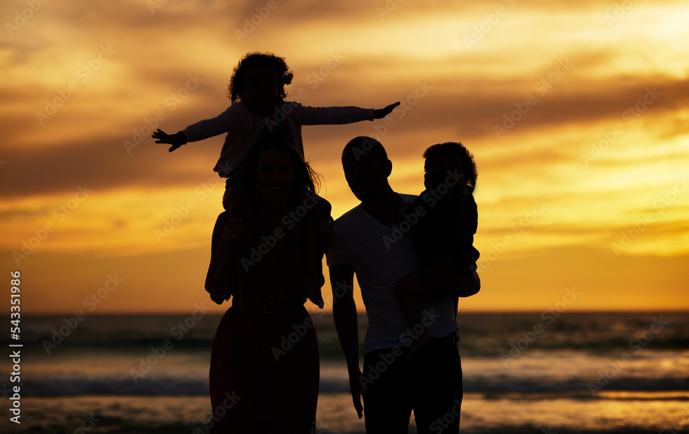 Beach, sunset and silhouette of family on vacation, holiday or trip outdoors. Love, care and shadow, outline or profile of man, woman and kids enjoying quality time together or bonding by seashore.