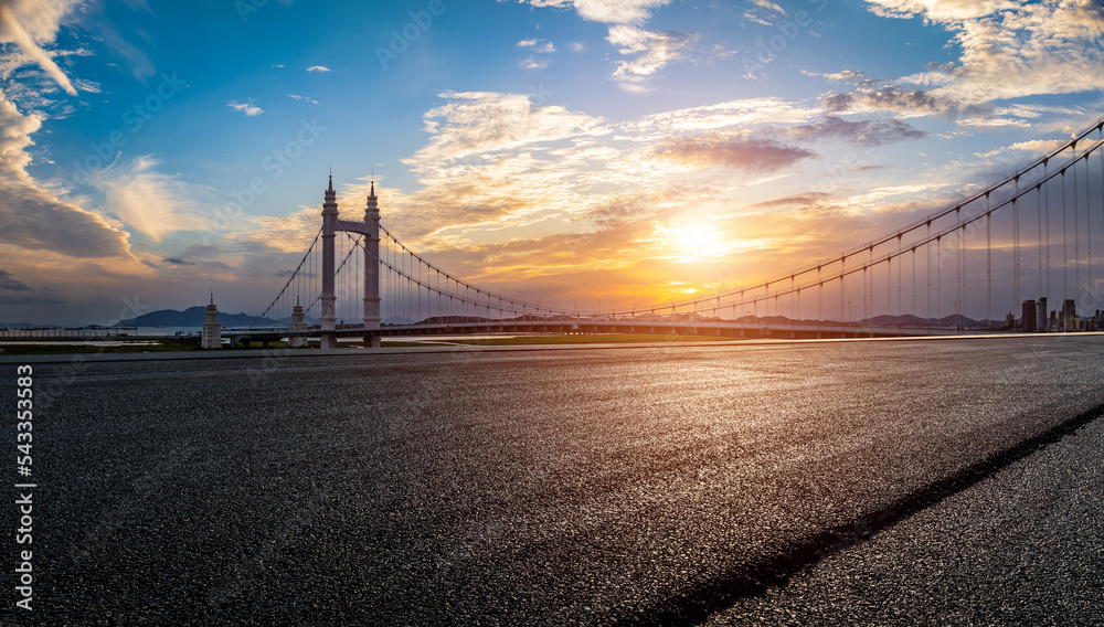 Empty asphalt road and bridge building with beautiful sky clouds at sunset - obrazy, fototapety, plakaty 