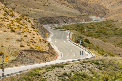 Scenic view of a twisty road in mountains leading to Queenstown, New Zealand photo