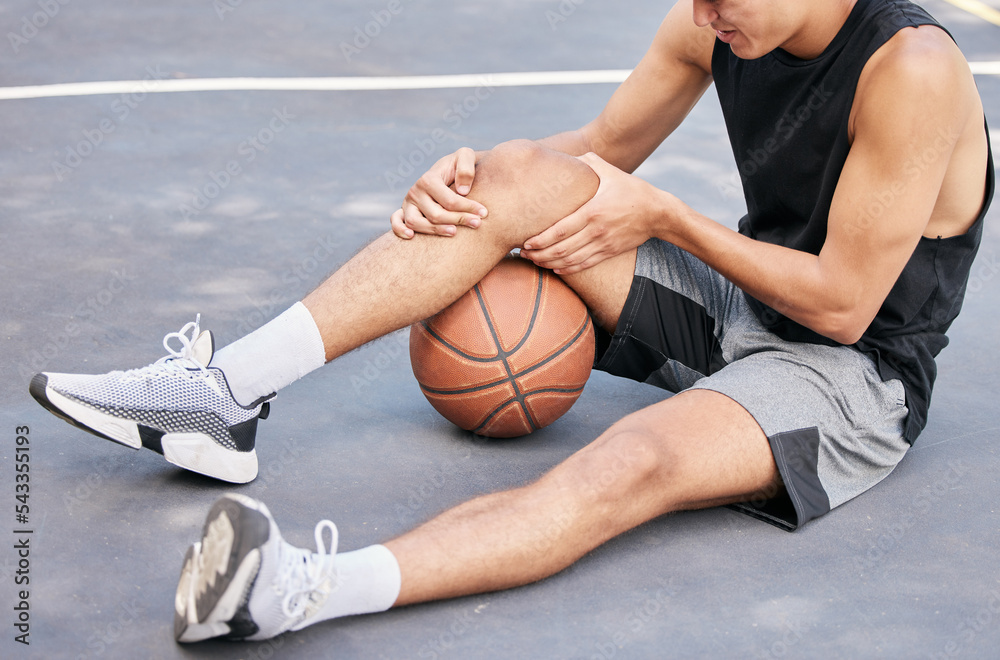 Basketball, man and knee in sports injury on the court holding painful, sore  or tender area