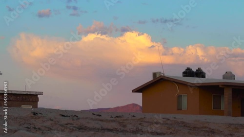 early sunrise with orange clouds and pink mountains photo