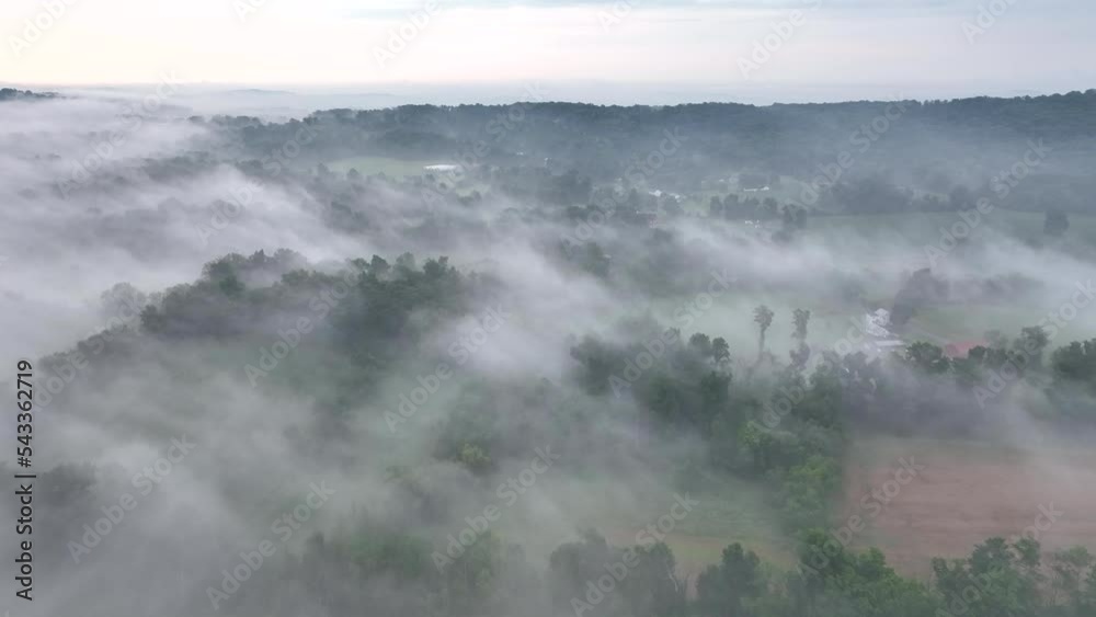 A beautiful aerial view of the fog covered landscape in the early morning light. A beautiful aerial view of the fog covered landscape in the early morning light.