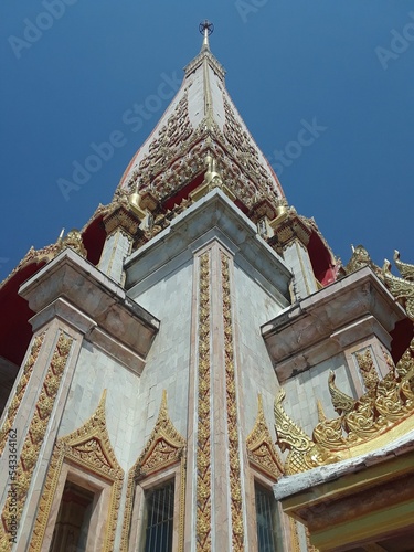 Low angle shot of Wat Phra That Prasit temple on blue sky background in Na Wa, Thailand photo