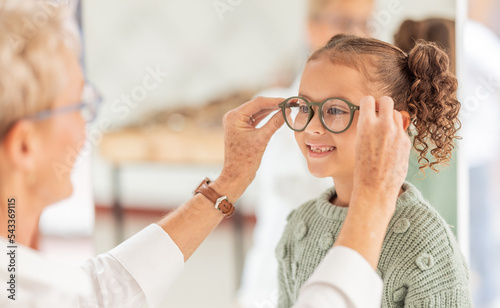 Vision, eye care glasses and child with optometrist for ophthalmology consultation, help or support with eyesight. Healthcare service, optical check and expert consulting youth patient at eye exam photo