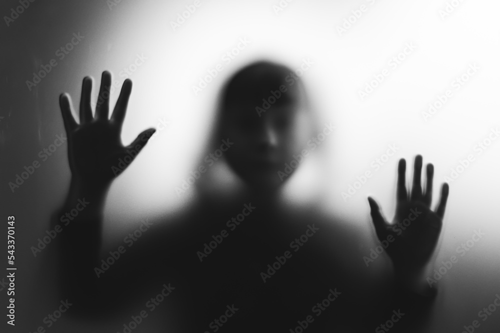 Shadowy figure, child behind glass - horror background
