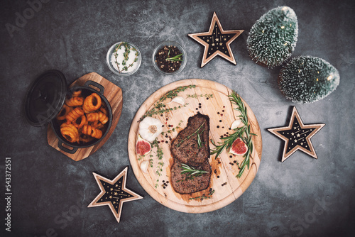 steak and christmas decoration on the table photo