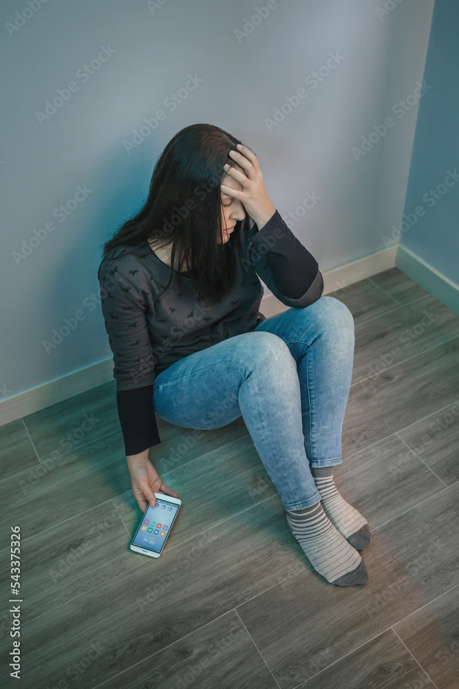Woman holding mobile desperate for problems with social networks Woman holding mobile desperate for problems with social networks