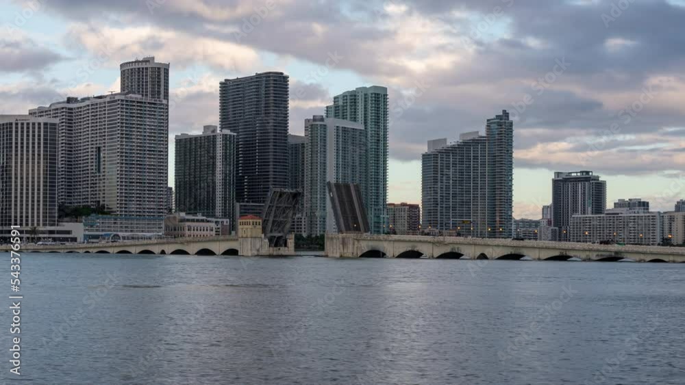 Zooming Time lapse of Venetian Cause Way Bridge in Miami, Florida, USA with a sailboat passing under