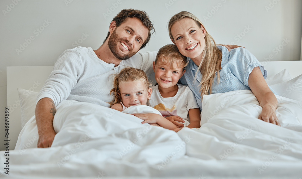 Fototapeta premium Family, children and bed with a girl, sister and parents in the bedroom of a home to relax together in the morning. Portrait, love and smile with a happy mother, father and daughter siblings bonding