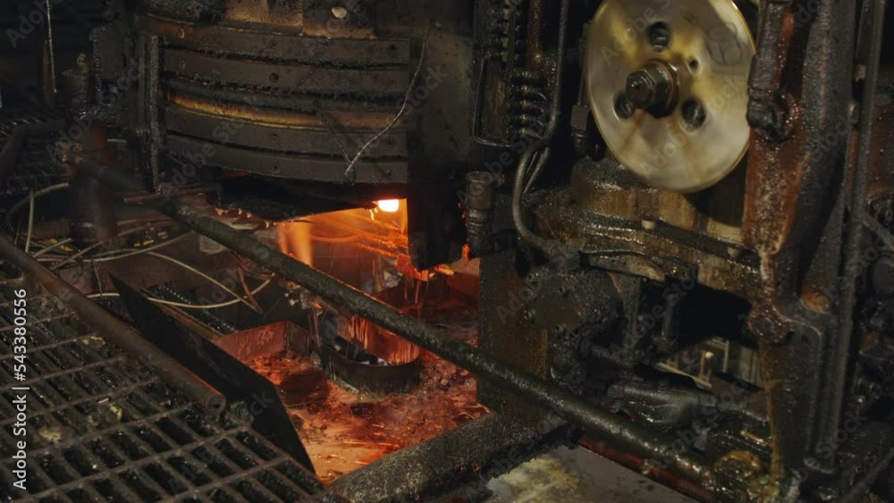 Molten glass pouring out of a Glass melting furnace in a bottle production facility. Glass recycling Molten glass pouring out of a Glass melting furnace in a bottle production facility. Glass recycling