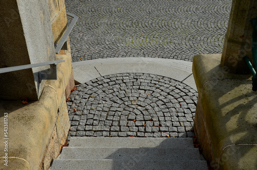 stairs to the waterfront. you enter through the gate via the circularly arranged cone-shaped stairs, breaking apart like the overflow of a clock, lawn, bench, seat, gray, granite, wall  urban, street photo