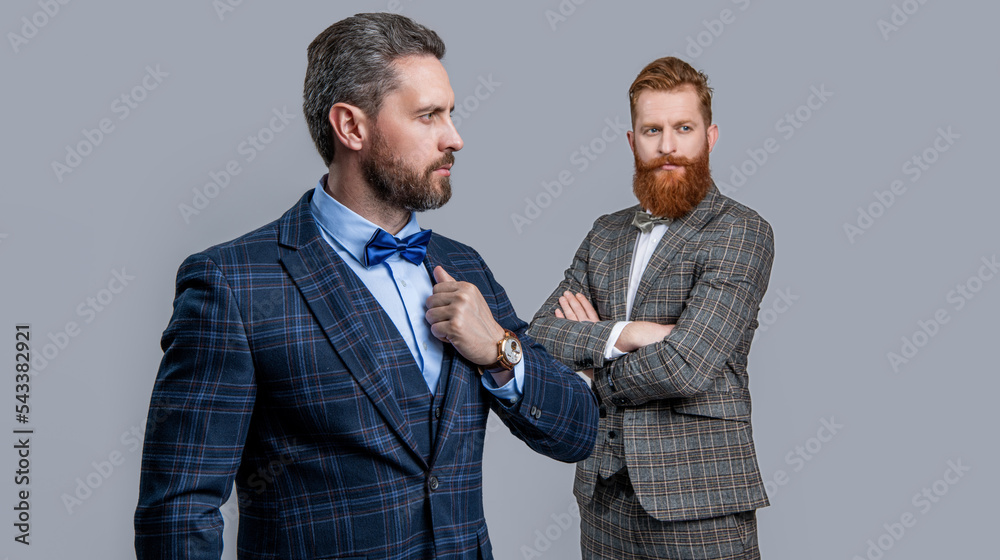 studio shot of men wearing bowtie and tux, selective focus. elegant men in formal tux suit studio shot of men wearing bowtie and tux, selective focus. elegant men in formal tux suit