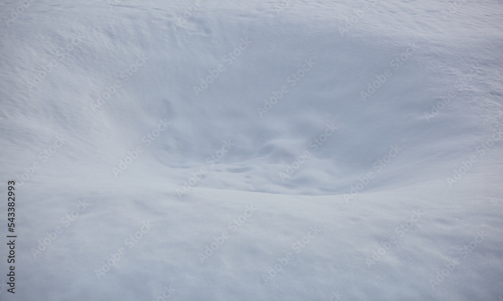 Hole in the snow surface. Blurred image, selective focus Hole in the snow surface. Blurred image, selective focus