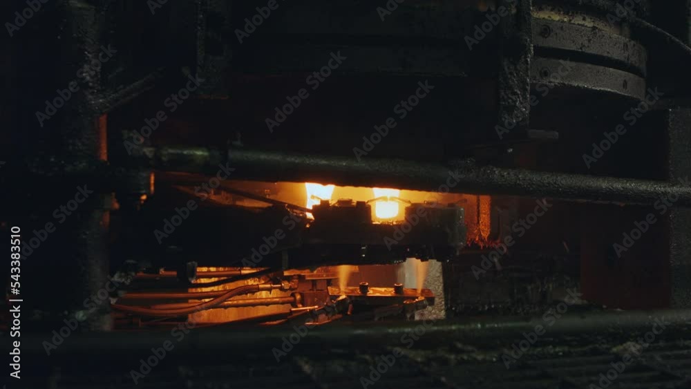 Molten glass pouring out of a Glass melting furnace in a bottle production facility. Glass recycling Molten glass pouring out of a Glass melting furnace in a bottle production facility. Glass recycling