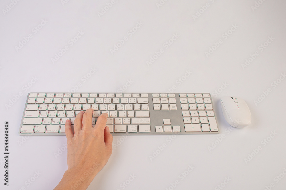 Closeup of business woman hand typing on laptop keyboard with mouse Closeup of business woman hand typing on laptop keyboard with mouse