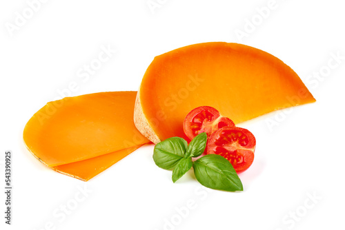 Wedge of orange French Mimolette cheese isolated on white background.