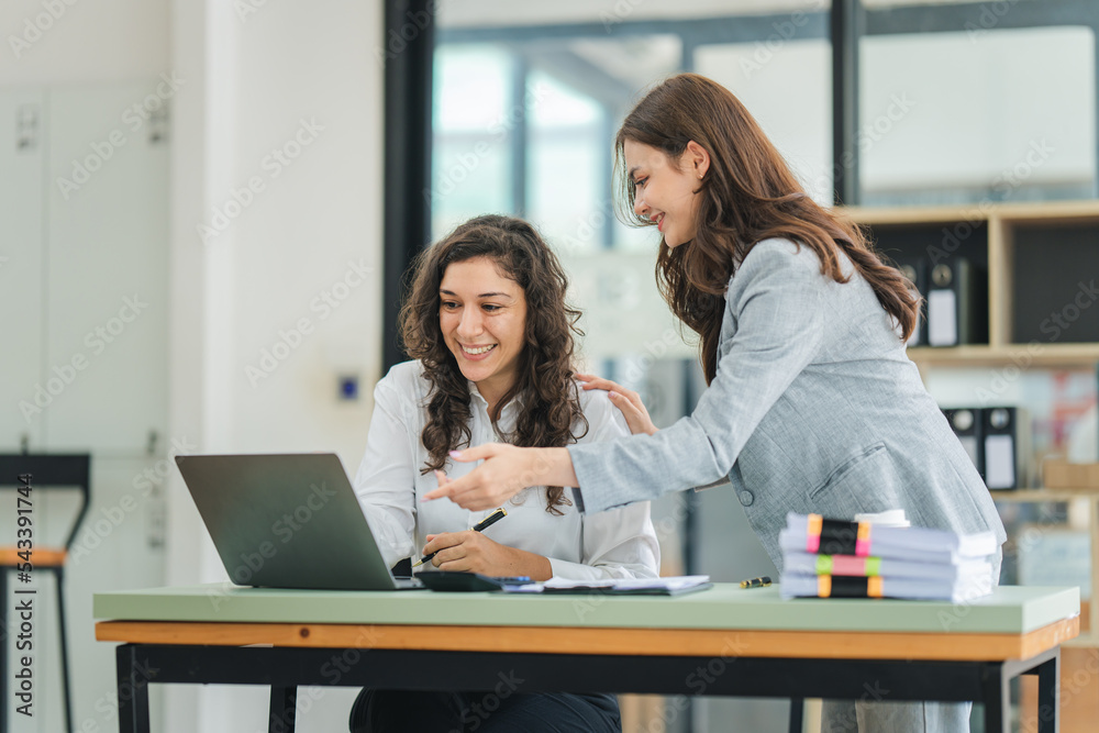 Young colleagues discussing business and price chart analyzes business people on the table great in modern coworking office teamwork concept. Young colleagues discussing business and price chart analyzes business people on the table great in modern coworking office teamwork concept.