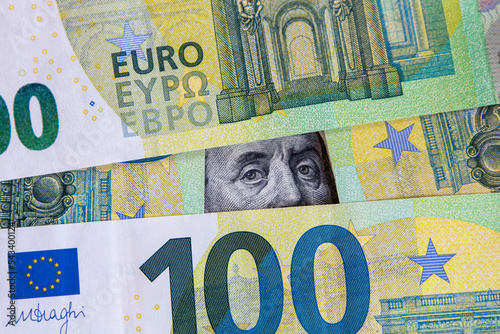 A hundred dollar bill lies among the bills of one hundred euros. Unstable exchange rate.