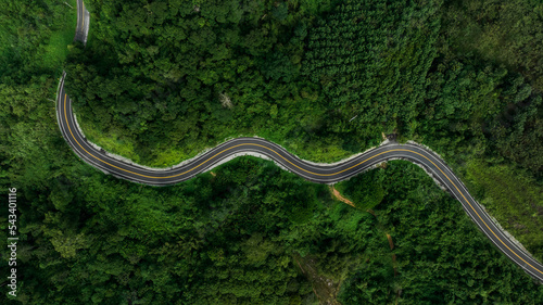 beautyfull curve road on green forest in the rain season background, rural routes connecting cities in the north of thailand © SHUTTER DIN