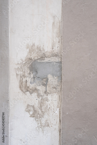 Old wall with chipped paint with cement 