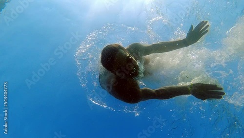 Wallpaper Mural Man Diving and Looking at Camera seen from Underneath Underwater Slow Motion Torontodigital.ca