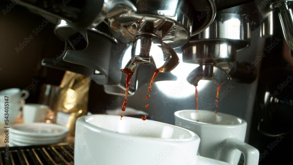 Close-up Slow Motion of Espresso Pouring from Coffee Machine. Filmed on High Speed Cinematic Camera at 1000 fps. Close-up Slow Motion of Espresso Pouring from Coffee Machine. Filmed on High Speed Cinematic Camera at 1000 fps.