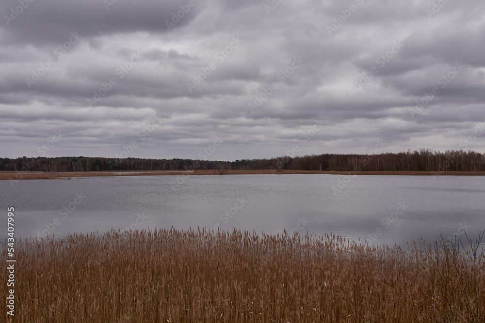 Cloudy sky over the autumn lake