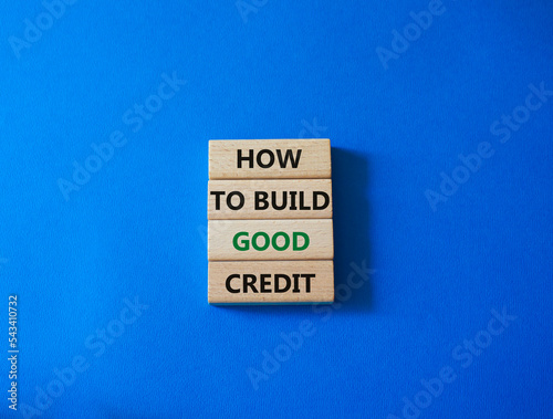 How to build good credit symbol. Concept words How to build good credit on wooden blocks. Beautiful blue background. Business and How to build good credit concept. Copy space.