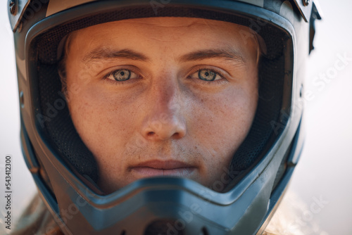 Fototapeta Naklejka Na Ścianę i Meble -  Face, helmet and extreme sports with a man biker outdoor alone for adventure or adrenaline. Portrait, safety and motocross with a confident male rider outside alone for fun or recreation closeup
